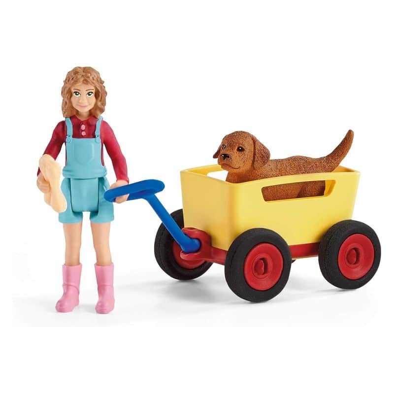 Figura de perro y niña paseo en carretilla de Schleich 42543